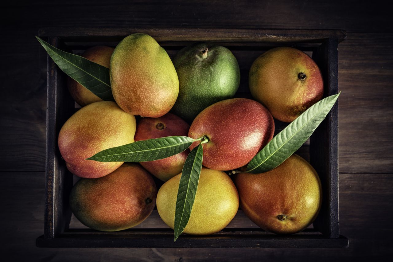 Wooden crate with assorted mangos