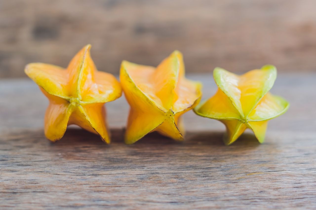 Star fruits on wooden table.
