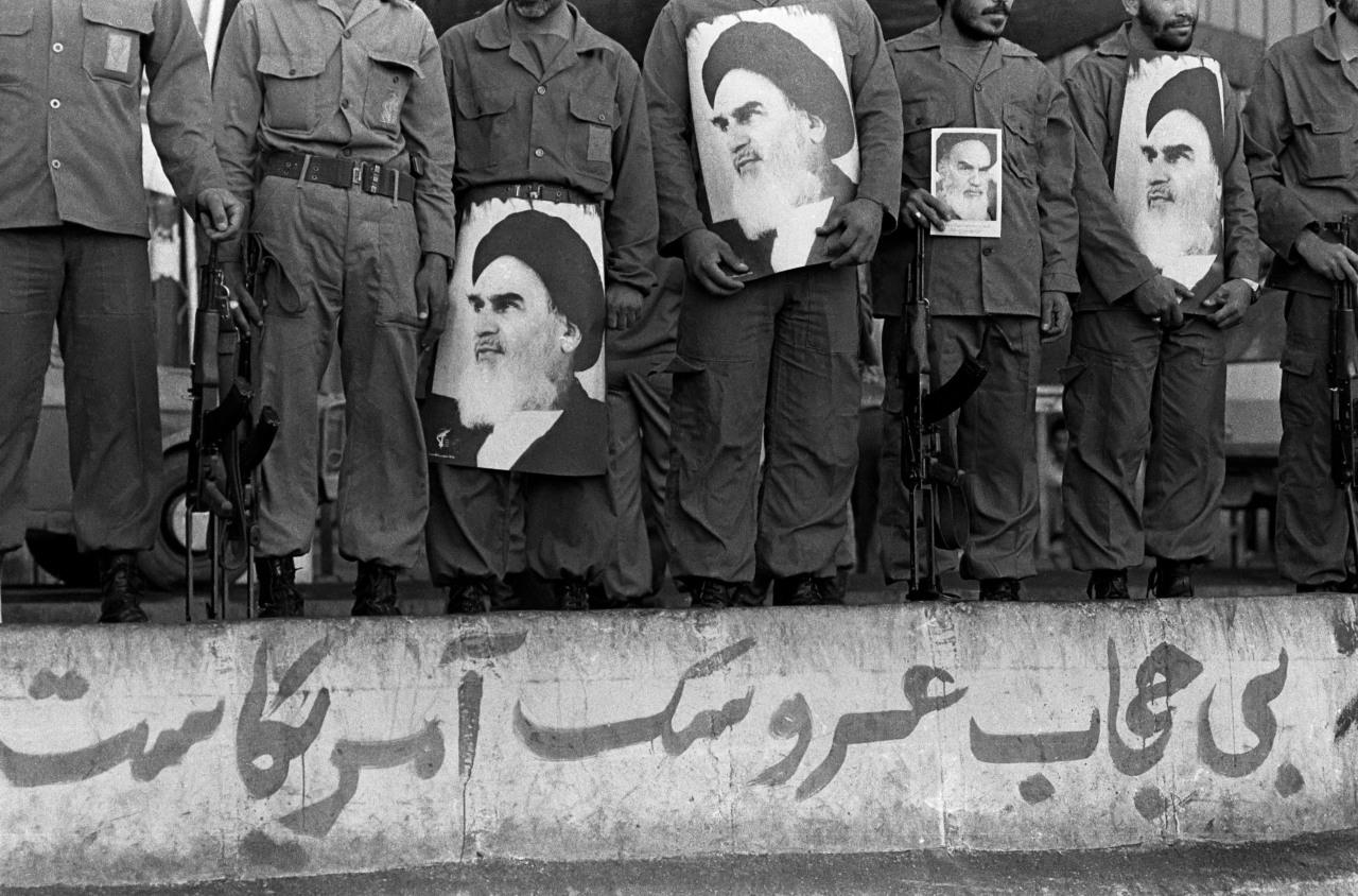 Revolutionary Guard Corps troops assembled in 1981 with weapons and images of Ayatollah Ruhollah Khomeini.