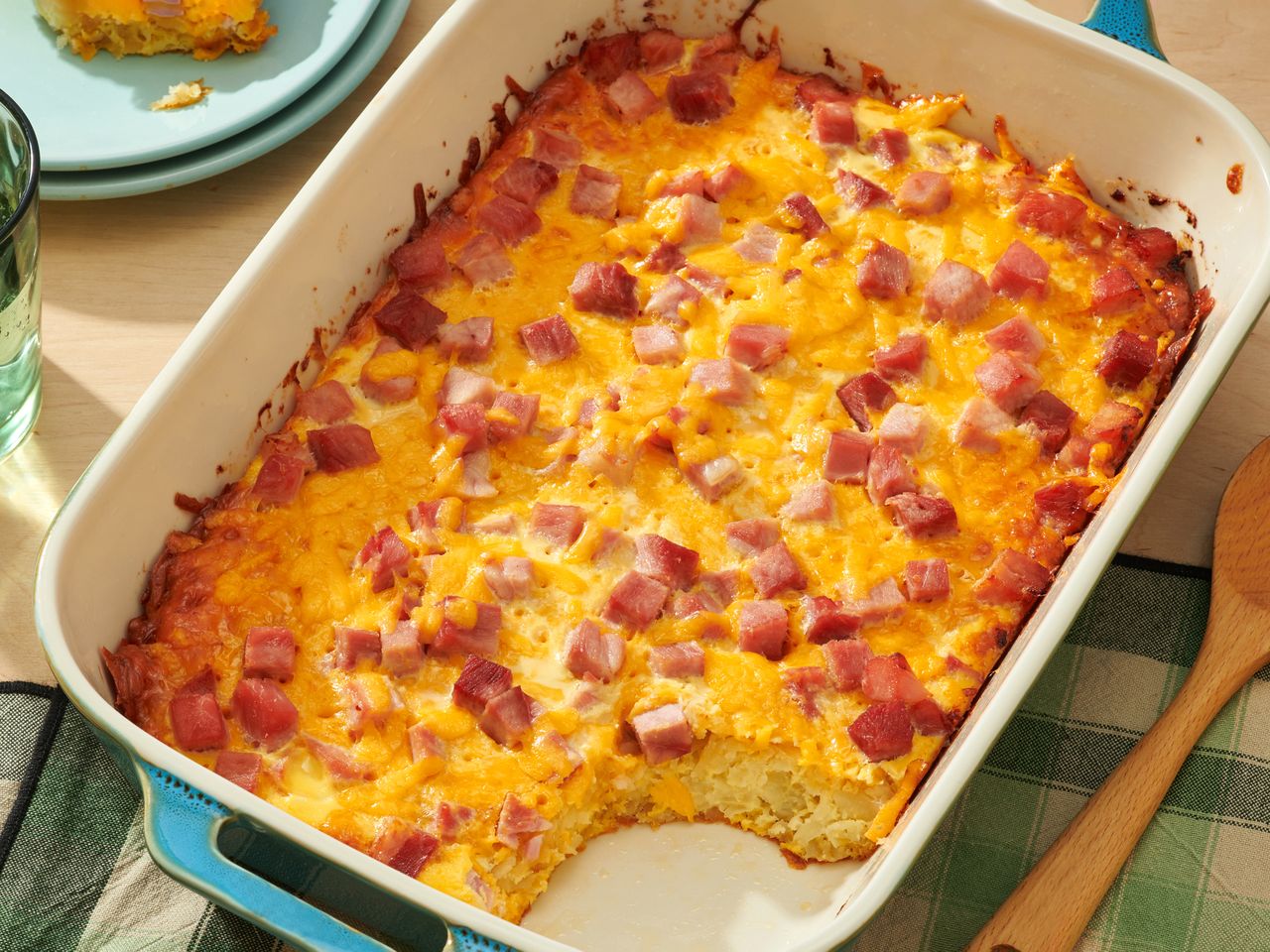 A casserole dish containing a breakfast bake with diced ham and cheese