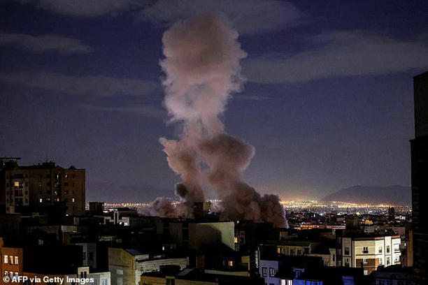 A smoke plume rises following a missile strike on a building in Tehran on March 1, 2026