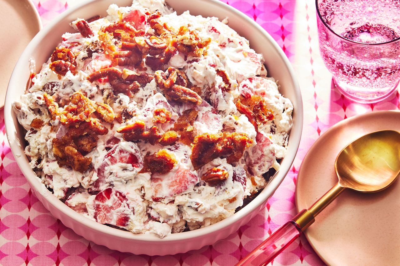 Strawberry Praline Salad in a bowl to serve on a table covered with a pink tablecloth