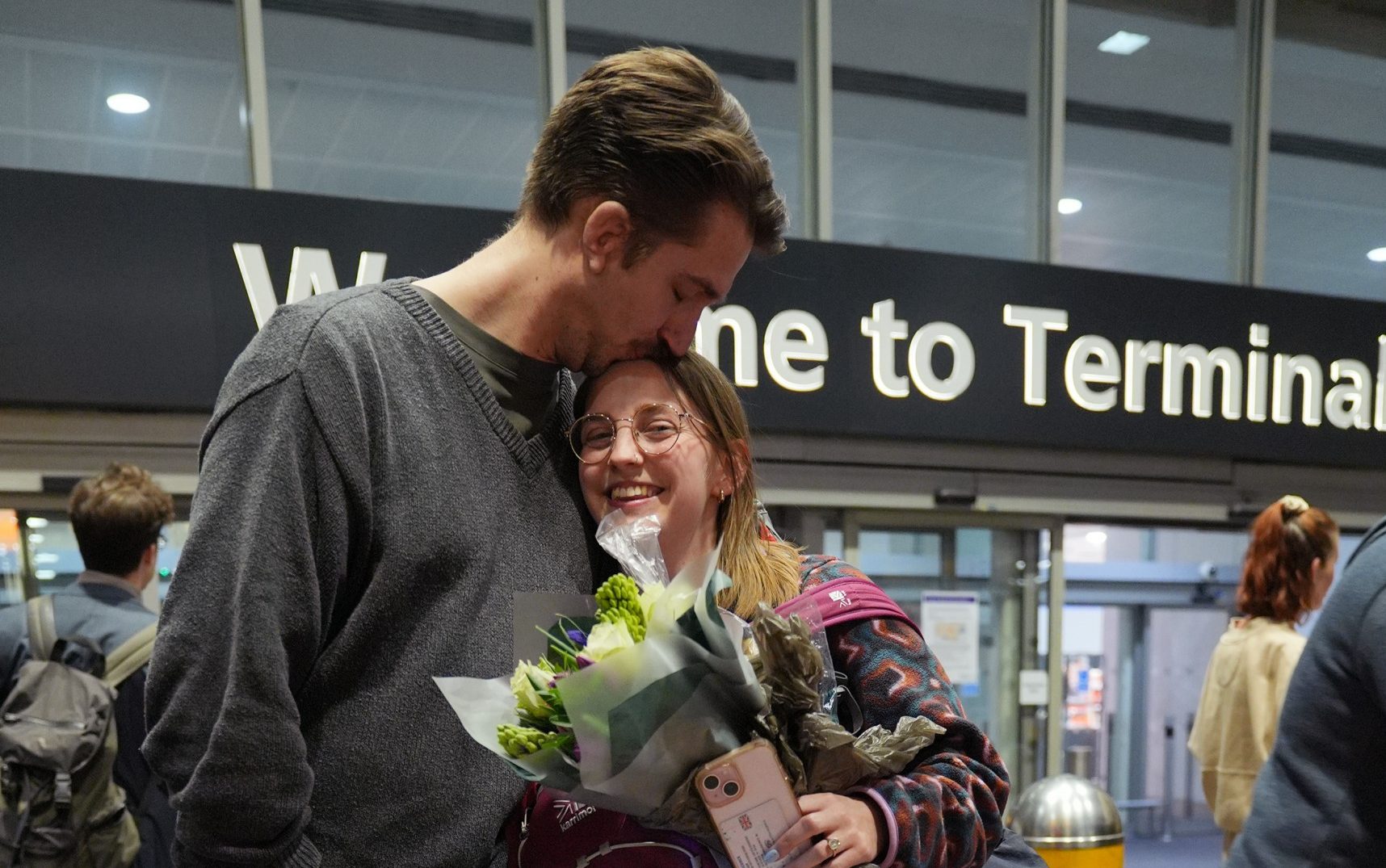 Cath Weaver, 26, is reunited with fiancé Don after arriving at Heathrow from Abu Dhabi - Yui Mok/PA