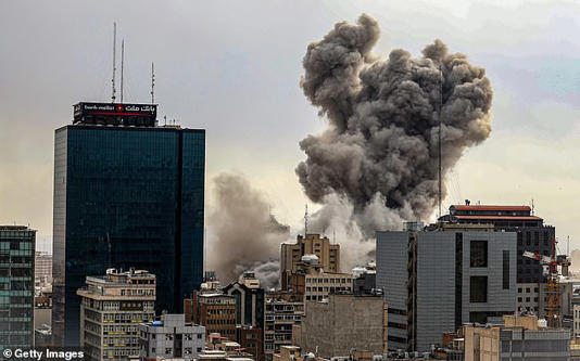 A general view of Tehran with smoke visible in the distance after explosions were reported in the city, on March 02, 2026 in Tehran, Iran