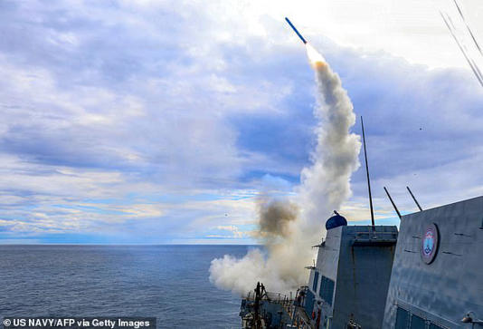 The US has two aircraft carrier strike units - amounting to roughly 15,000 soldiers - in the Middle East. Above a Arleigh-Burke class destroyer is seen firing a Tomahwak land attack missile at Iran