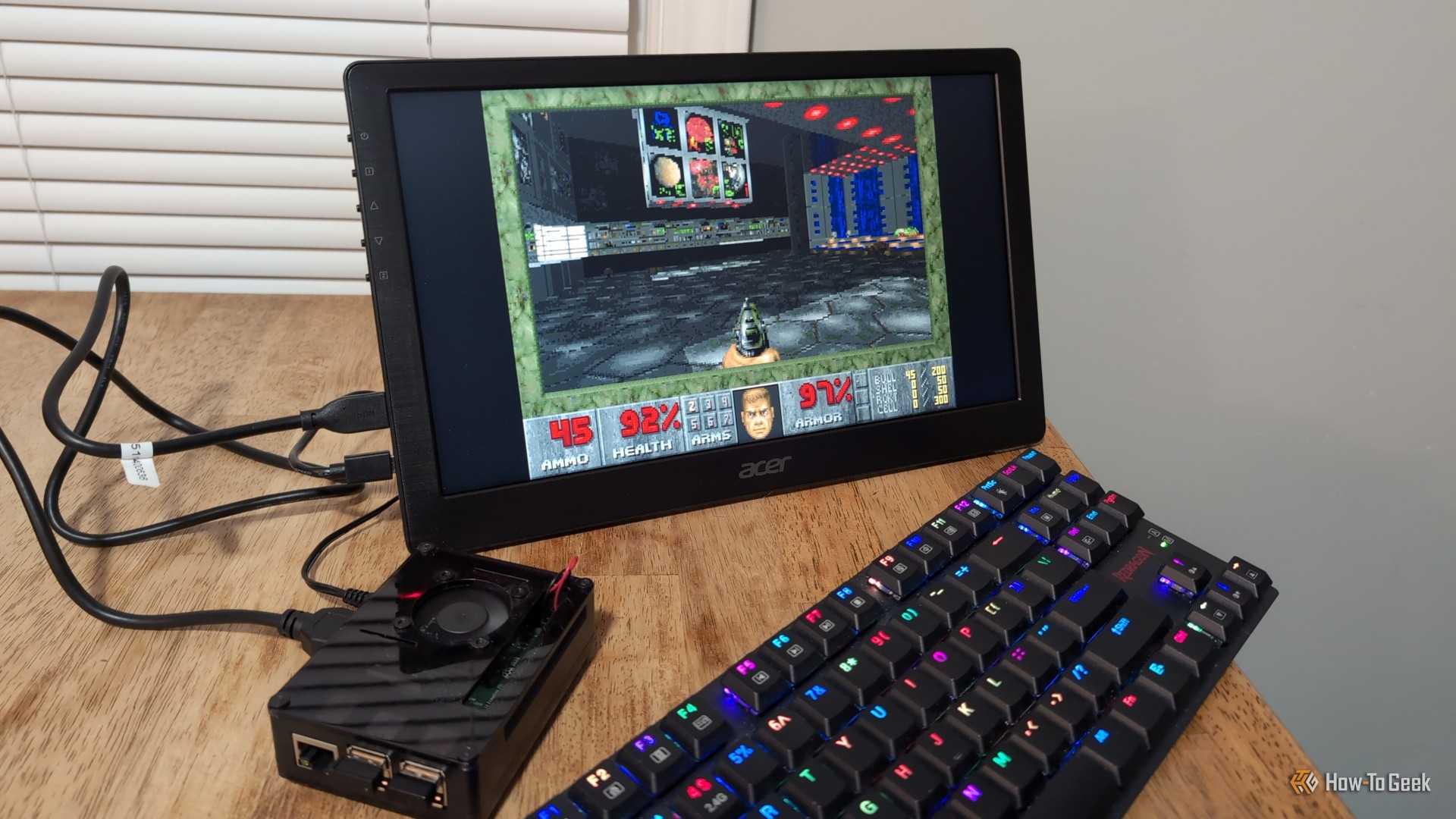 The original Doom game running on a Raspbery Pi with a portable monitor and a keyboard.