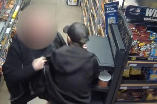There was a short tussle before the blurred-out cop tackled Gambier to the floor