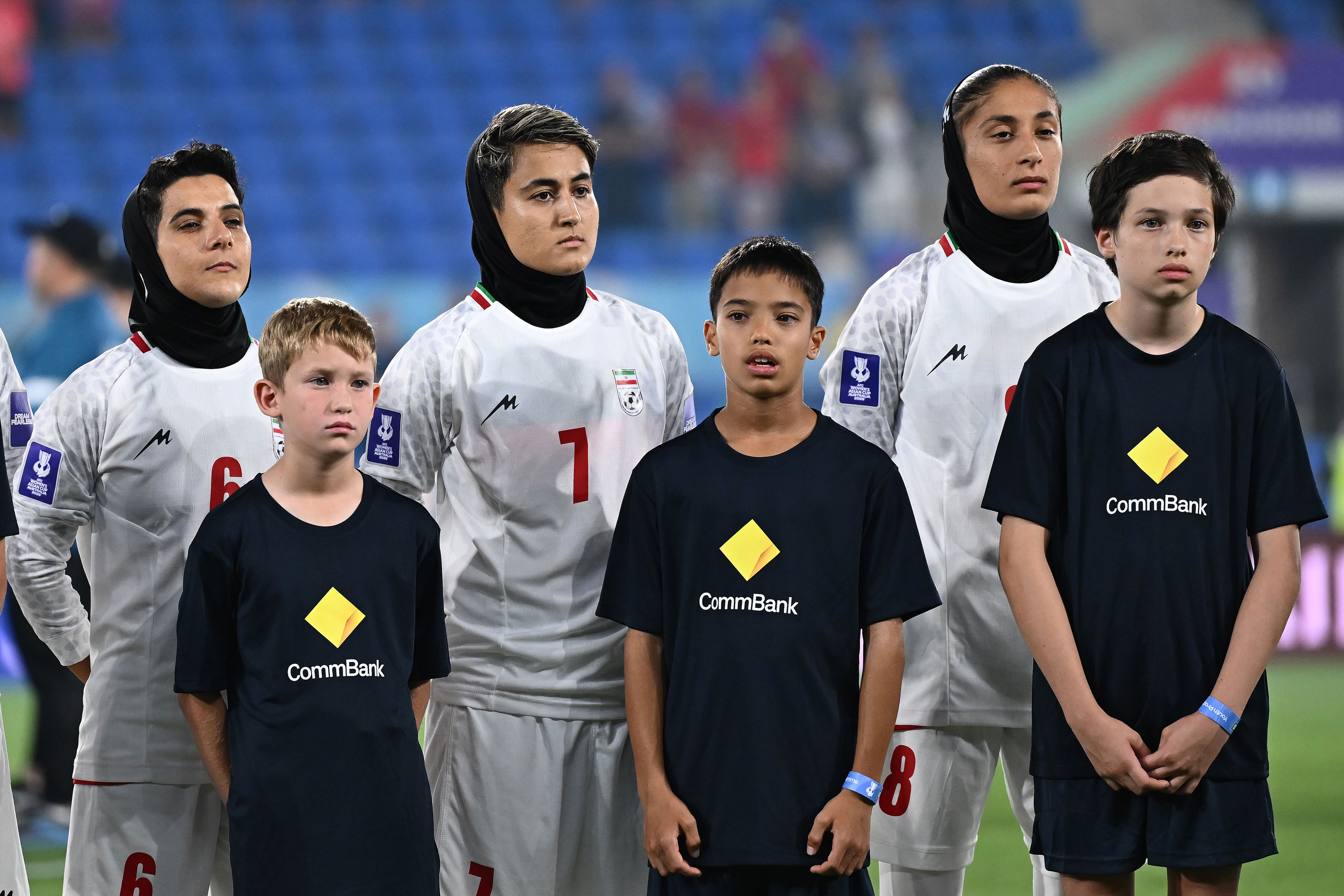 Iranian women's soccer team stands silent during national anthem