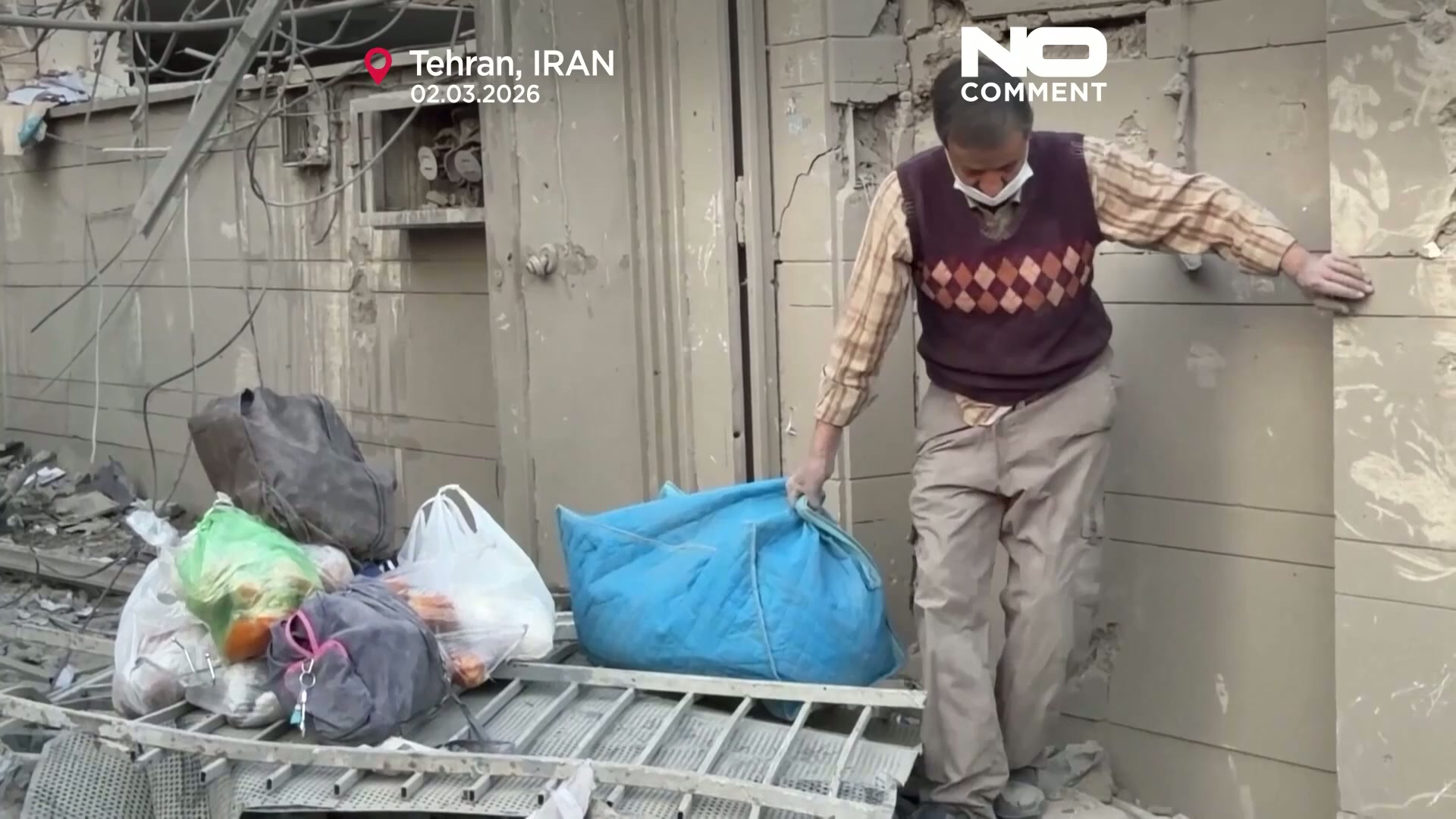 Workers clear rubble after US-Israeli strikes damage buildings in Tehran