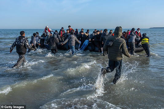 Migrants rushed to board a dangerously-overloaded inflatable dinghy