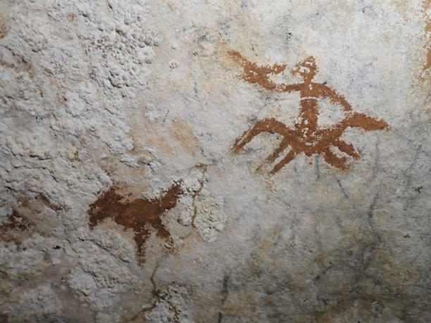 The Faint 67,800 Year Old Hand Stencil Is Barely Visible Amongst Much Younger Art