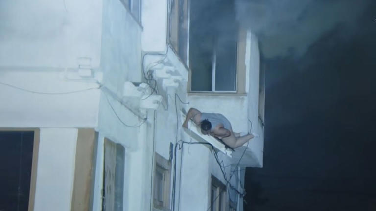 Terrifying moment woman jumps from 2nd-floor window as building erupts ...