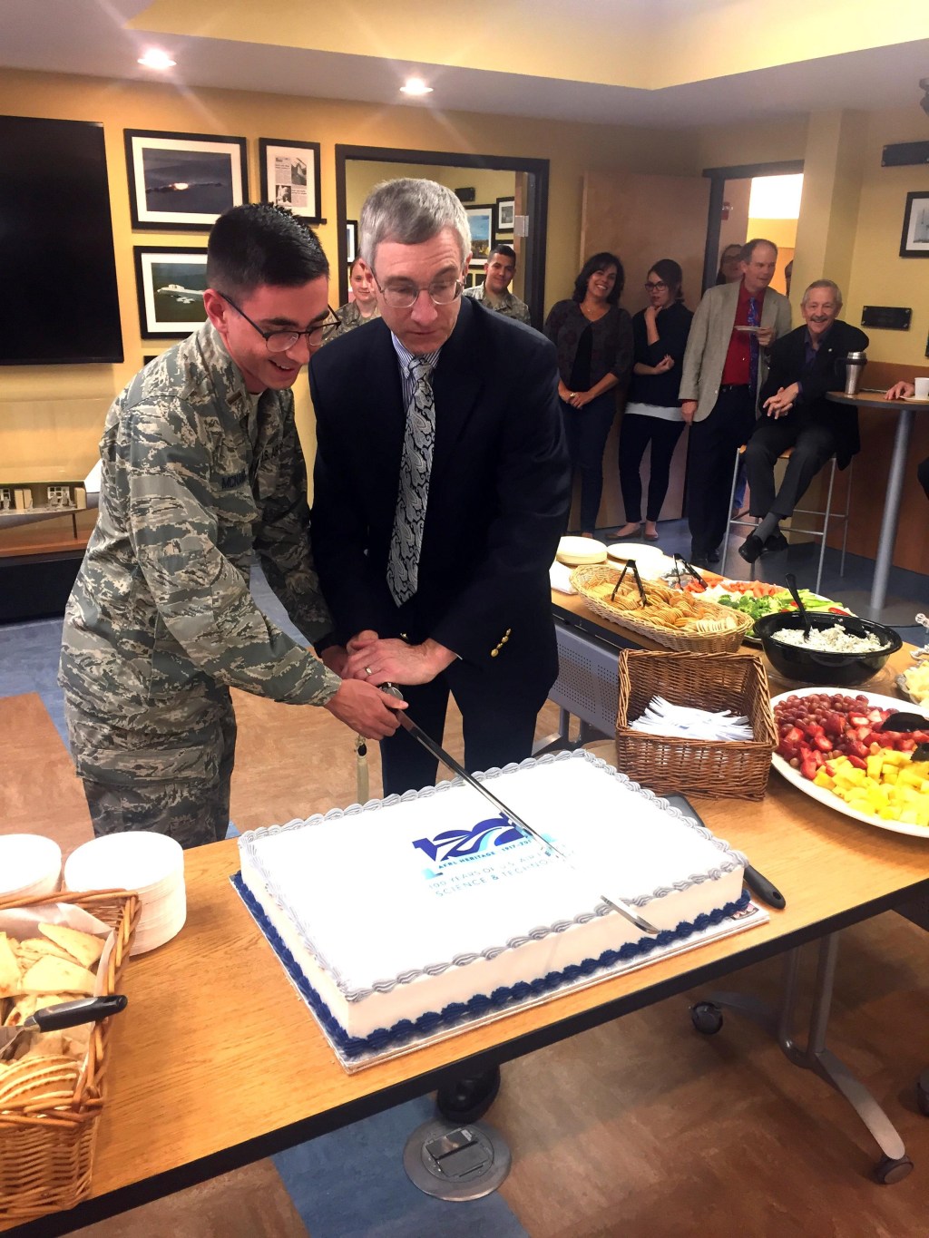 1st Lt. Steven McNamara (left) and McCasland cut the cake celebrating 100 years of heritage for the Air Force Research Laboratory at the Heritage Annex. Jim Fisher / United States Air Force