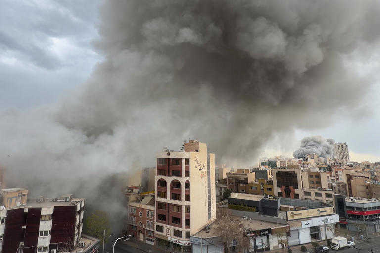 Plumes of smoke from two simultaneous strikes rise over Tehran, Iran, on 2 March 2026. Photograph: Mohsen Ganji/AP
