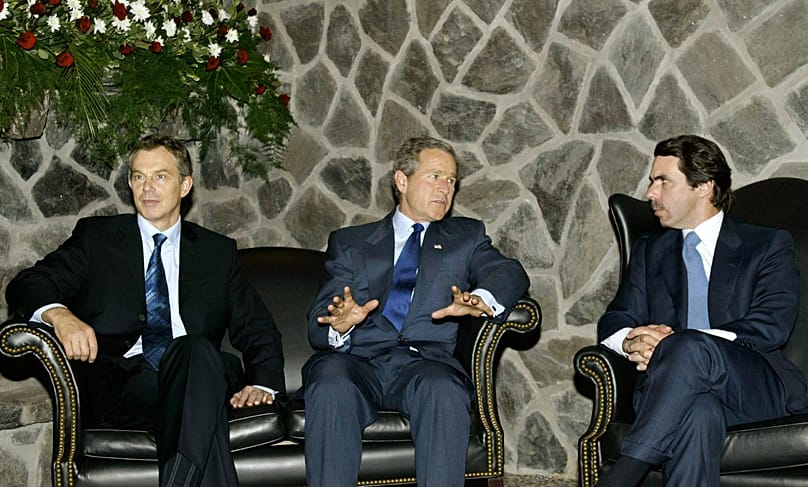 George W. Bush, en el centro, conversa con José María Aznar, a la derecha, y con Tony Blair, durante una cumbre sobre Irak, celebrada en las islas Azores en marzo de 2003. AP Photo