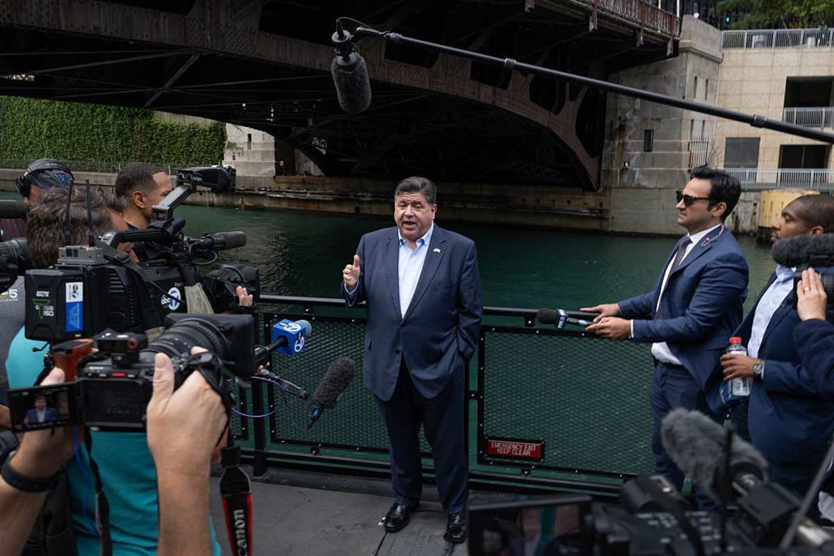 Illinois Governor JB Pritzker speaks to the media onboard a water taxi passing Trump Tower about plans by President Donald Trump to send National Guard troops into Chicago, on the Chicago River on August 25, 2025, in Chicago, Illinois (Scott Olson/Getty Images)