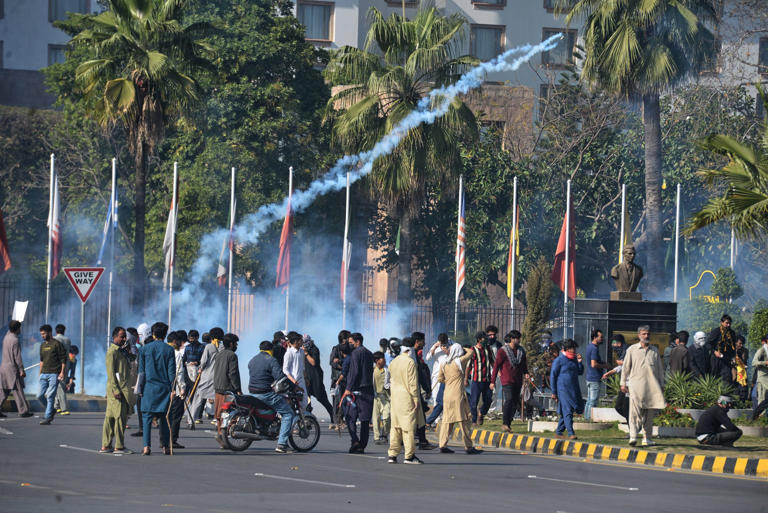 Shiite Muslims hurl back tear gas shell fired by police as they march towards the US embassy during a rally in Islamabad on Sunday to condemn the killing of Iranian supreme leader Ali Khamenei. Photo: AP