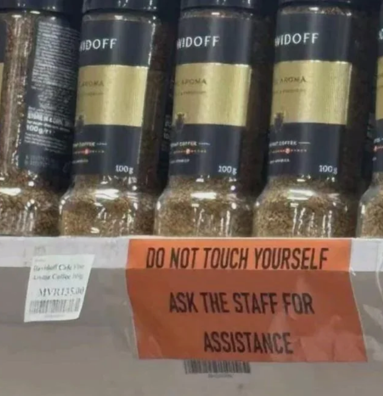 Sign on shelf reads: "Do not touch yourself. Ask the staff for assistance."