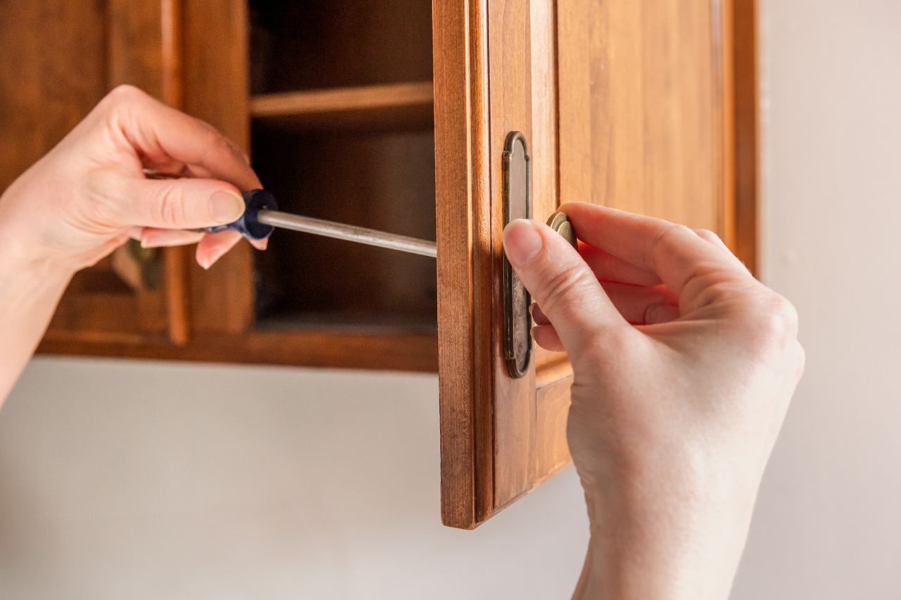 Cleaning hardware on a wood cabinet