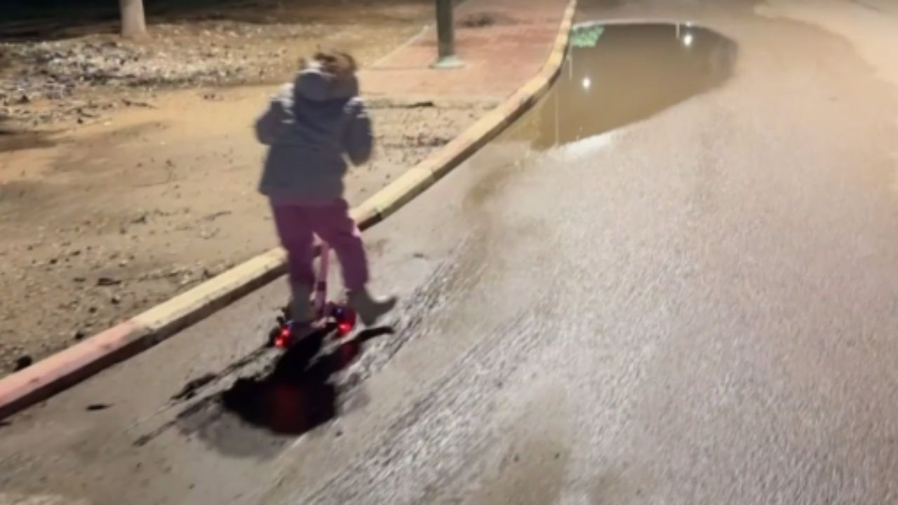 Little girl enjoys riding her scooty but falls straight into muddy water