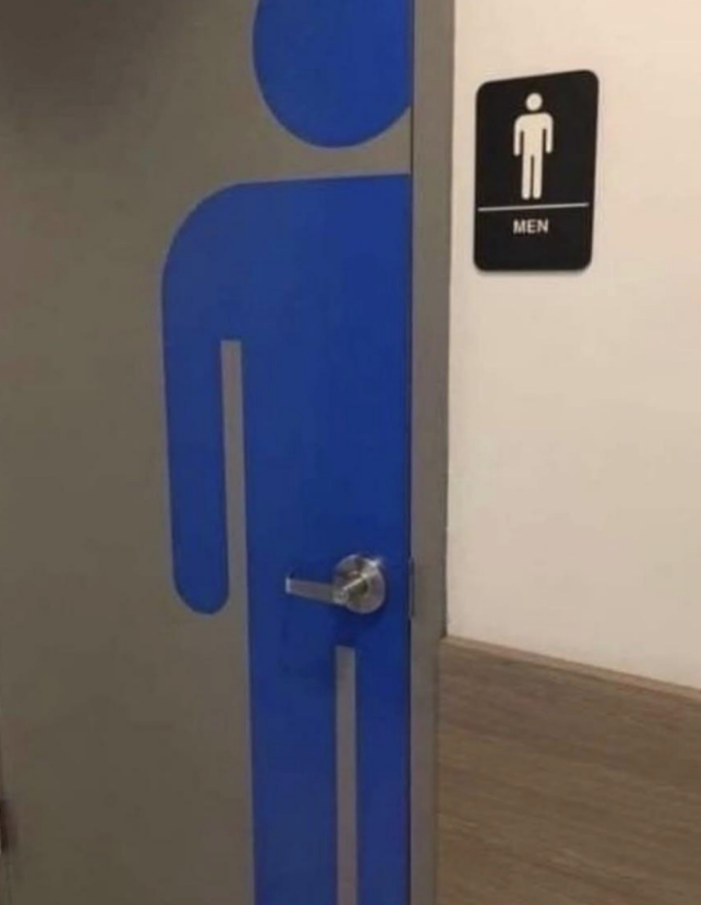 Men's restroom door with a blue stylized figure, partially open
