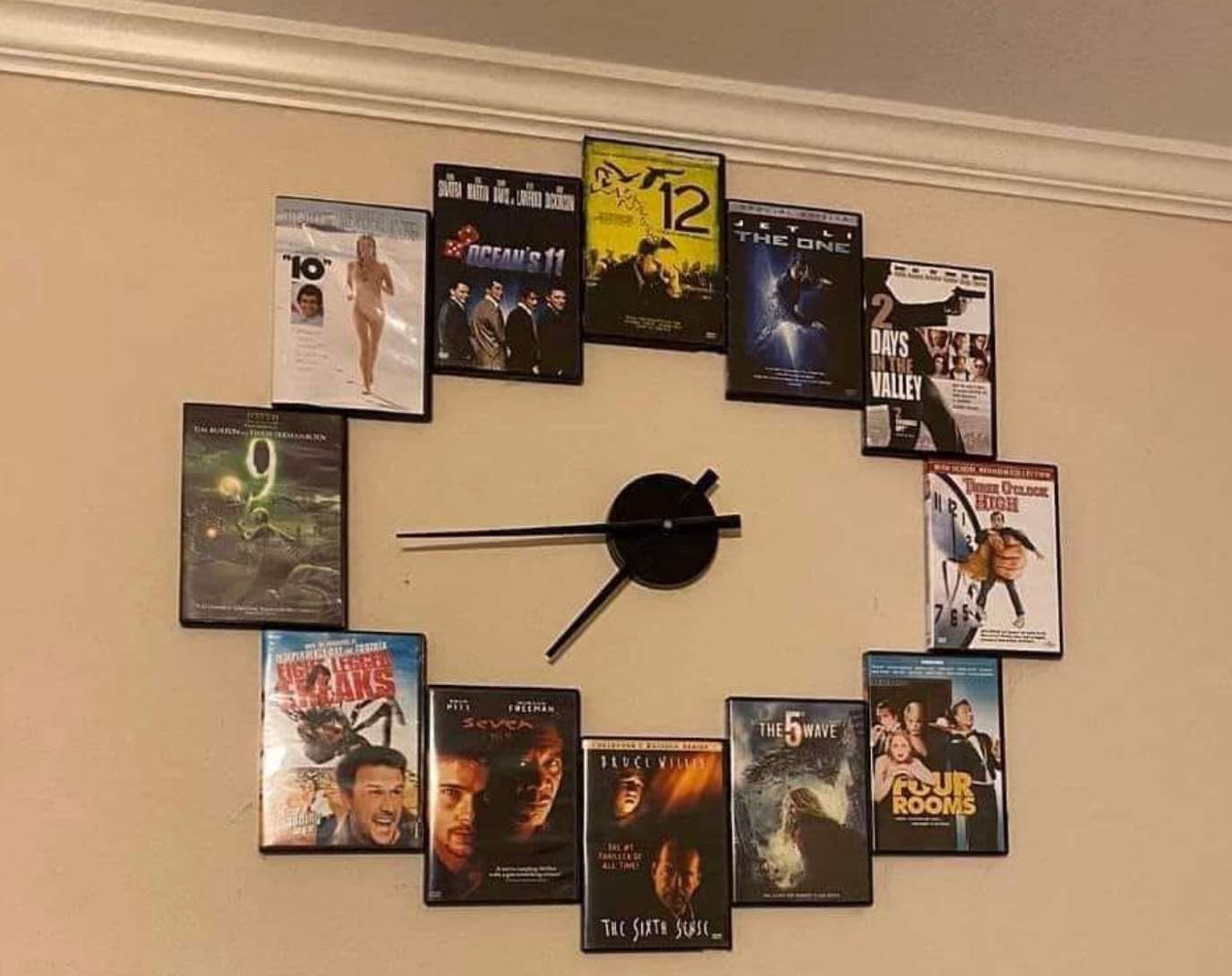 Wall clock with DVD cases forming the numbers, creating a unique and creative clock design