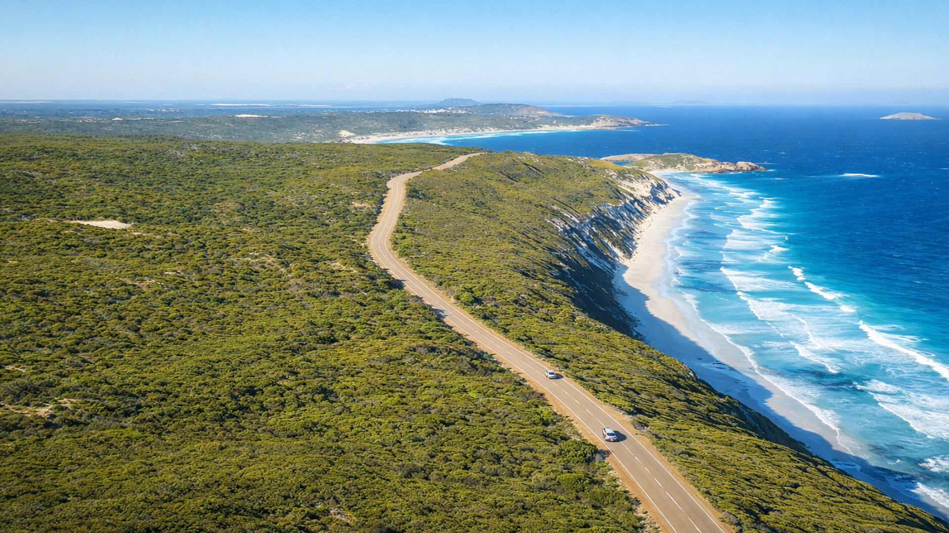 A road that cuts through the edge of the ocean