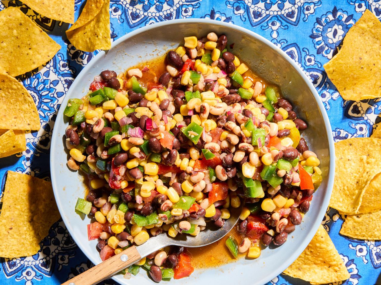 Bowl of cowboy caviar surrounded by tortilla chips
