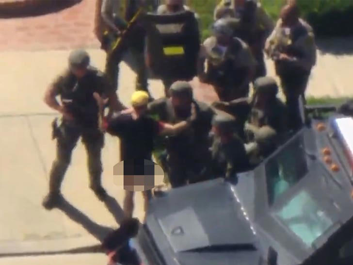 Suspect without pants surrenders to SWAT team after standoff, on video
