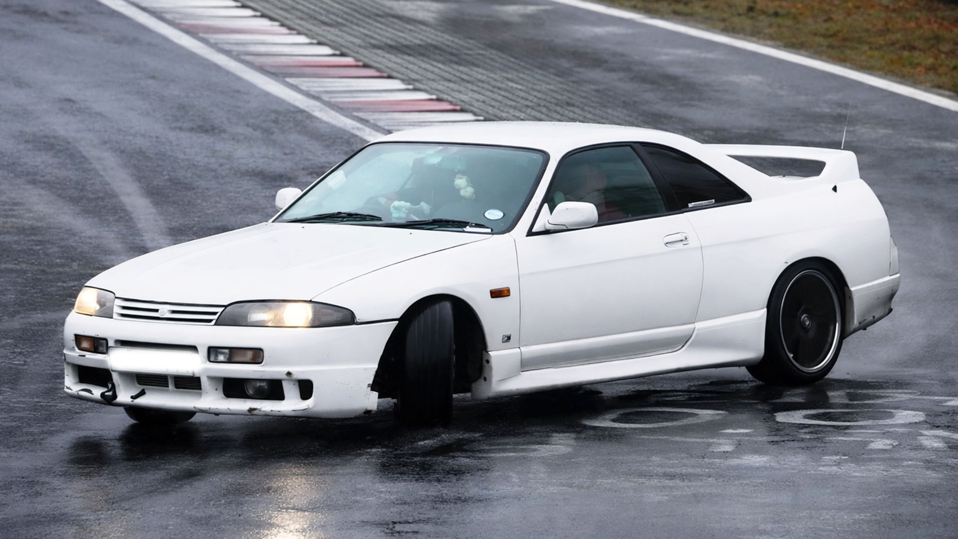 Drivers test JDM cars on wet Nürburgring track