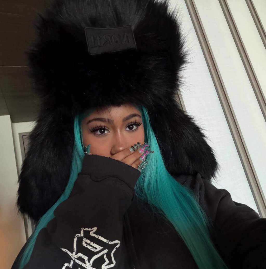 North West is seen above showing off her new manicure featuring piercings via Instagram Stories on Thursday. North West/Instagram