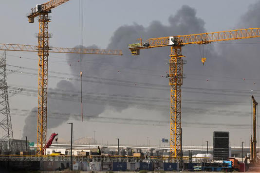 A plume of smoke rises from the port of Jebel Ali