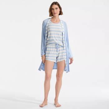 Person modeling a casual lounge set with a robe, top, and shorts, suitable for comfortable indoor wear
