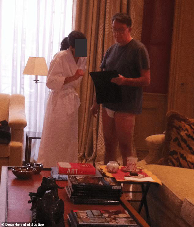 This photo, released by the US Department of Justice as part of the Epstein Files, shows Peter Mandelson next to a woman wearing a bathrobe while is standing in his underwear