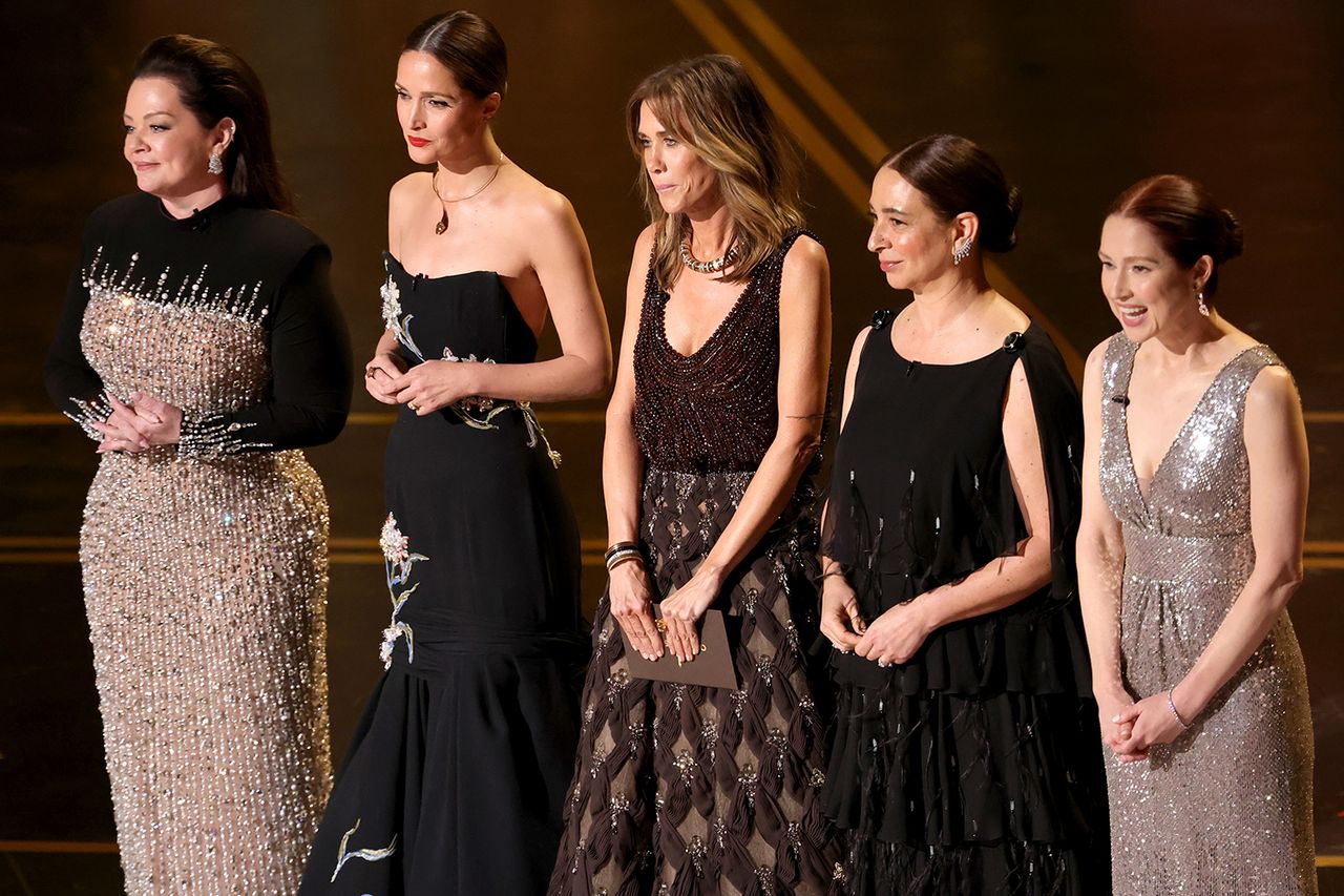 From left: Melissa McCarthy, Rose Byrne, Kristen Wiig, Maya Rudolph, and Ellie Kemper speak onstage during the 98th Oscars at Dolby Theatre on March 15, 2026 in Los Angeles, Calif. Credit: Kevin Winter/Getty