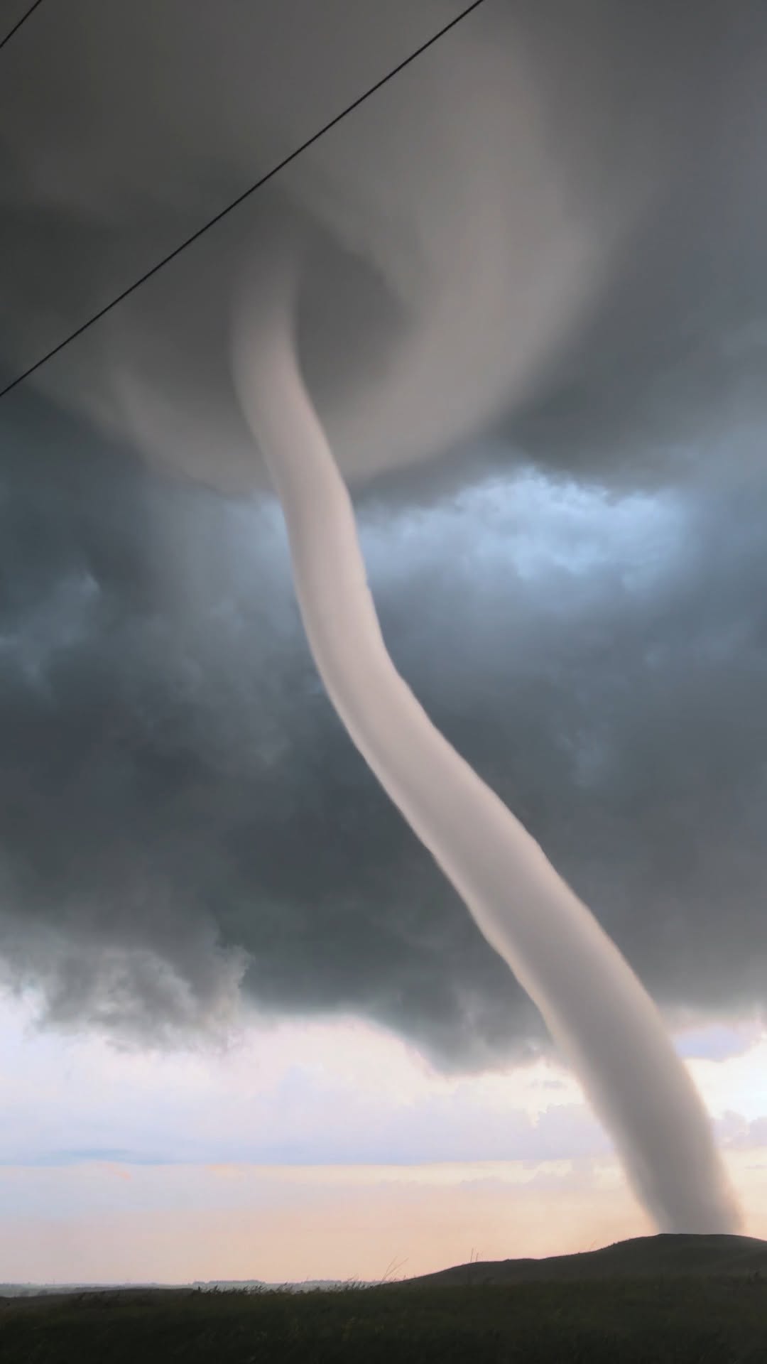 Violent EF3 tornado twisting across open fields<br>