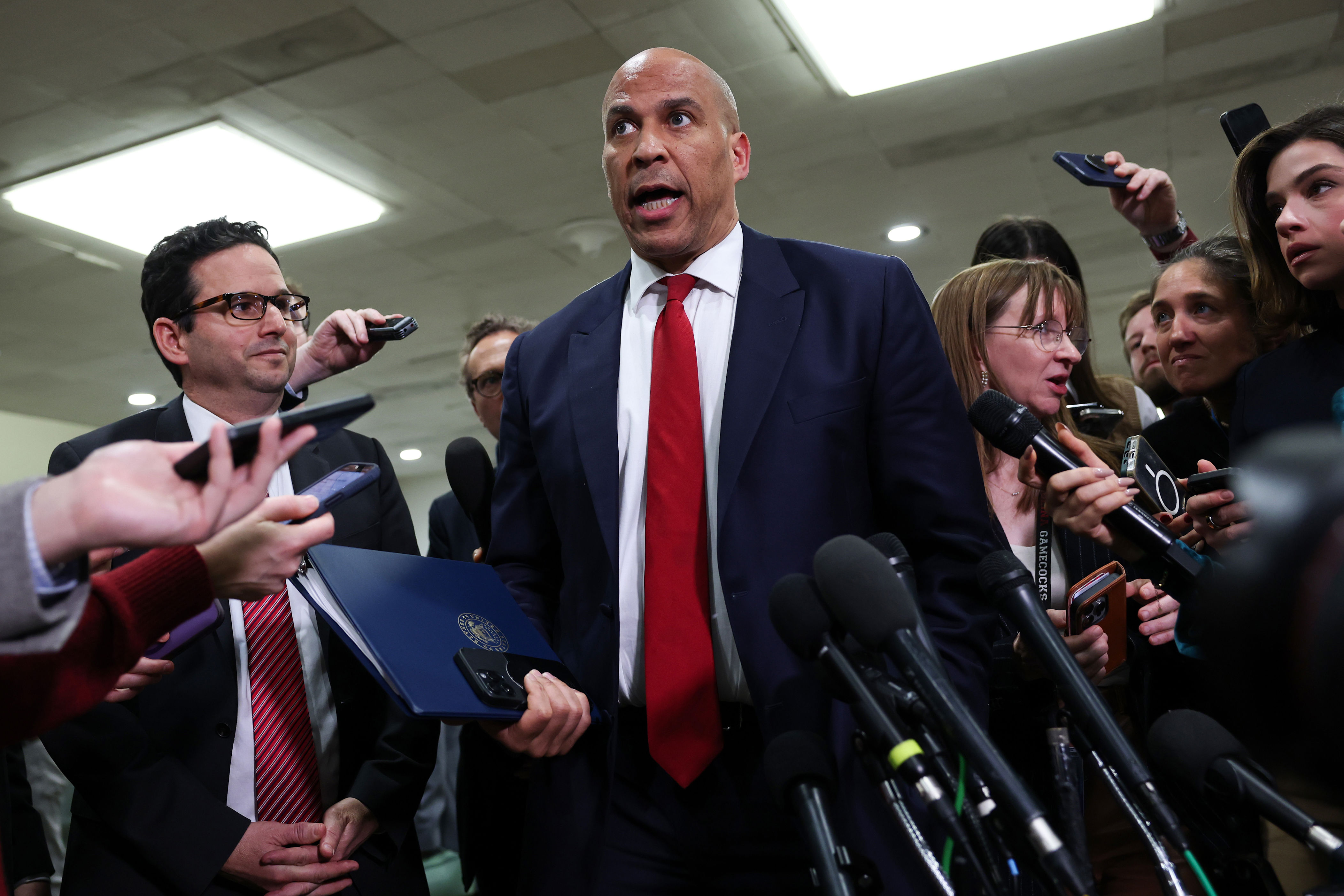 Cory Booker surrounded by reporters. 