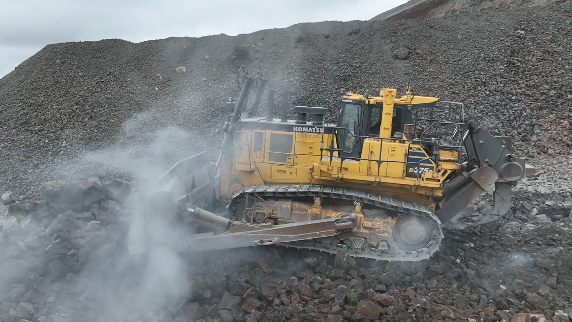 This giant machine pushes mountains of rock