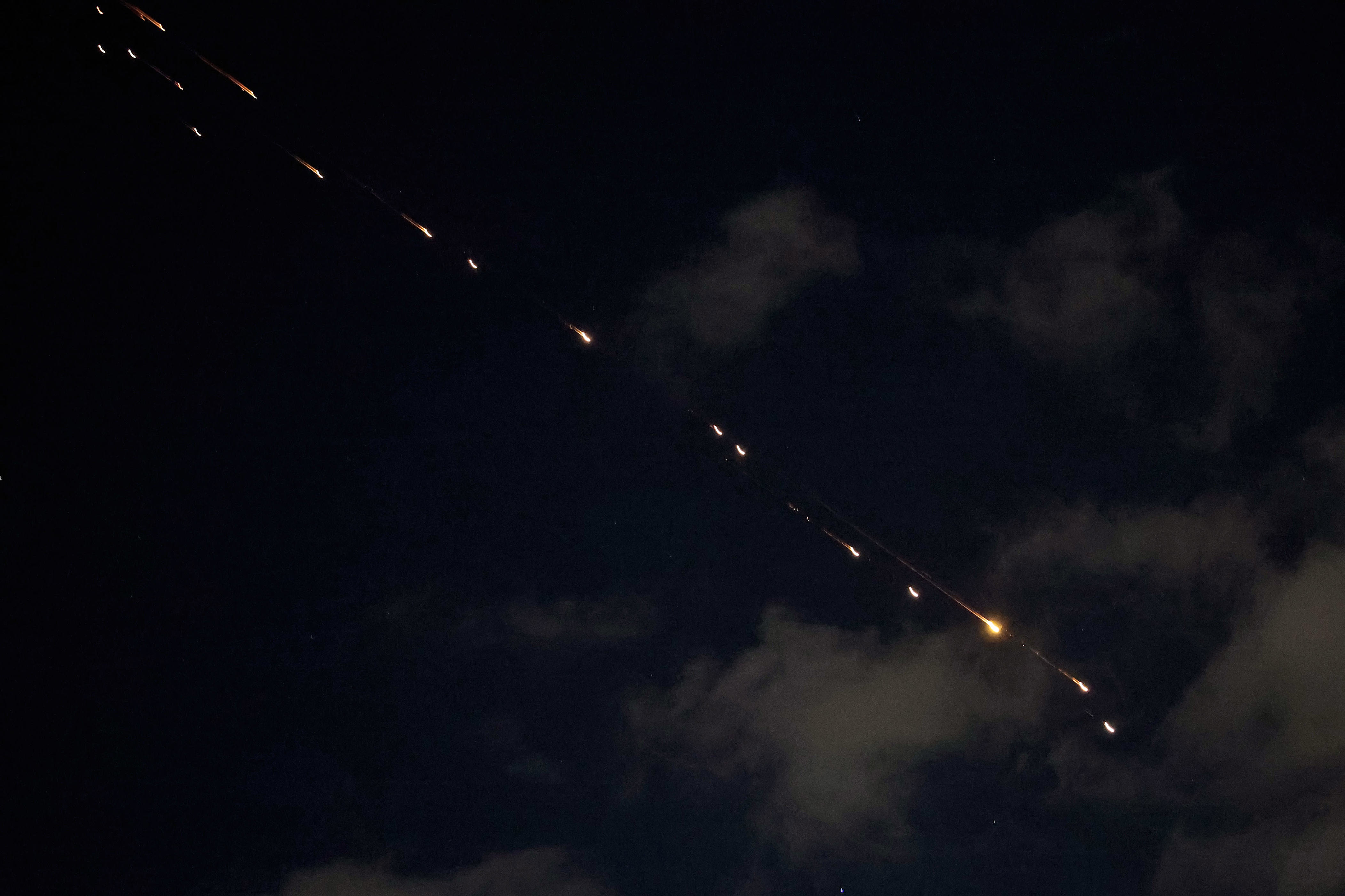 What are cluster munitions and how does Israel intercept them?