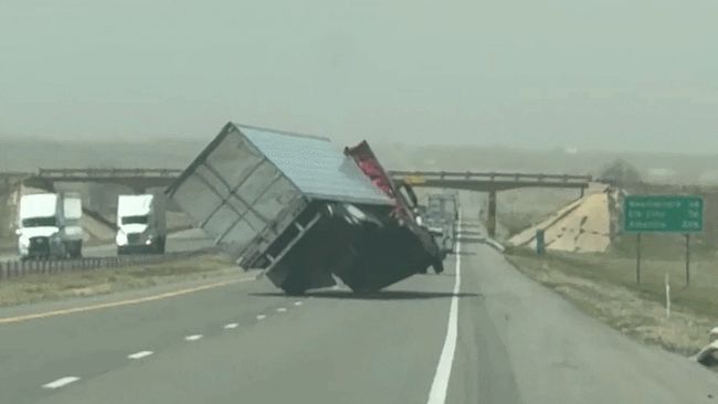 Tractor trailer teeters and topples in intense wind