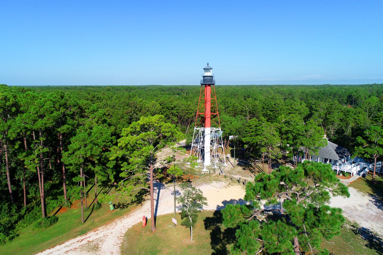 Crooked River Lighthouse surrounded by trees in Carrabelle Florida