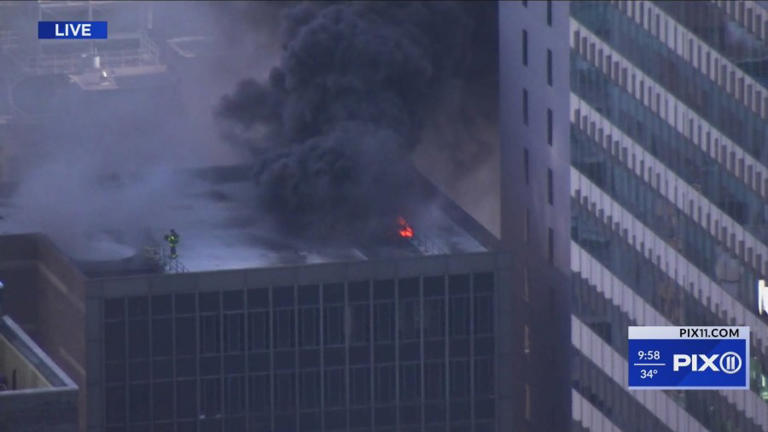 Fire sends smoke billowing from roof of Midtown building