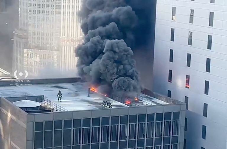 Midtown office building fire sends smoke billowing near parade route