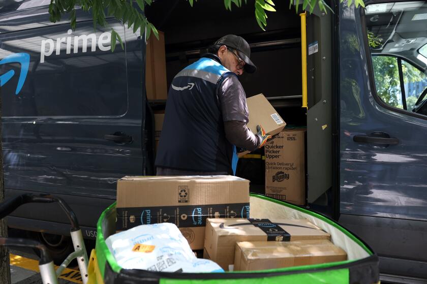 SAN FRANCISCO, CALIFORNIA - JULY 16: An Amazon delivery driver loads a cart with packages on July 16, 2024 in San Francisco, California. As the annual Amazon Prime Day is underway, the U.S. Senate's Health, Education, Labor and Pensions (HELP) Committee has made public early results of an investigation into working conditions at Amazon warehouses that reveal that Prime Day is a major cause of worker injuries. The committee received internal data from Amazon that showed total injuries on Prime Day 2019 were nearly 45 injuries per 100 workers. (Photo by Justin Sullivan/Getty Images)