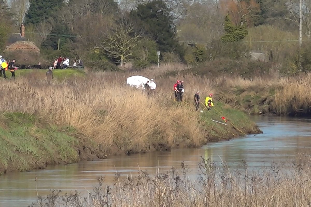 Divers recover body of teenage girl from river as search continues for male