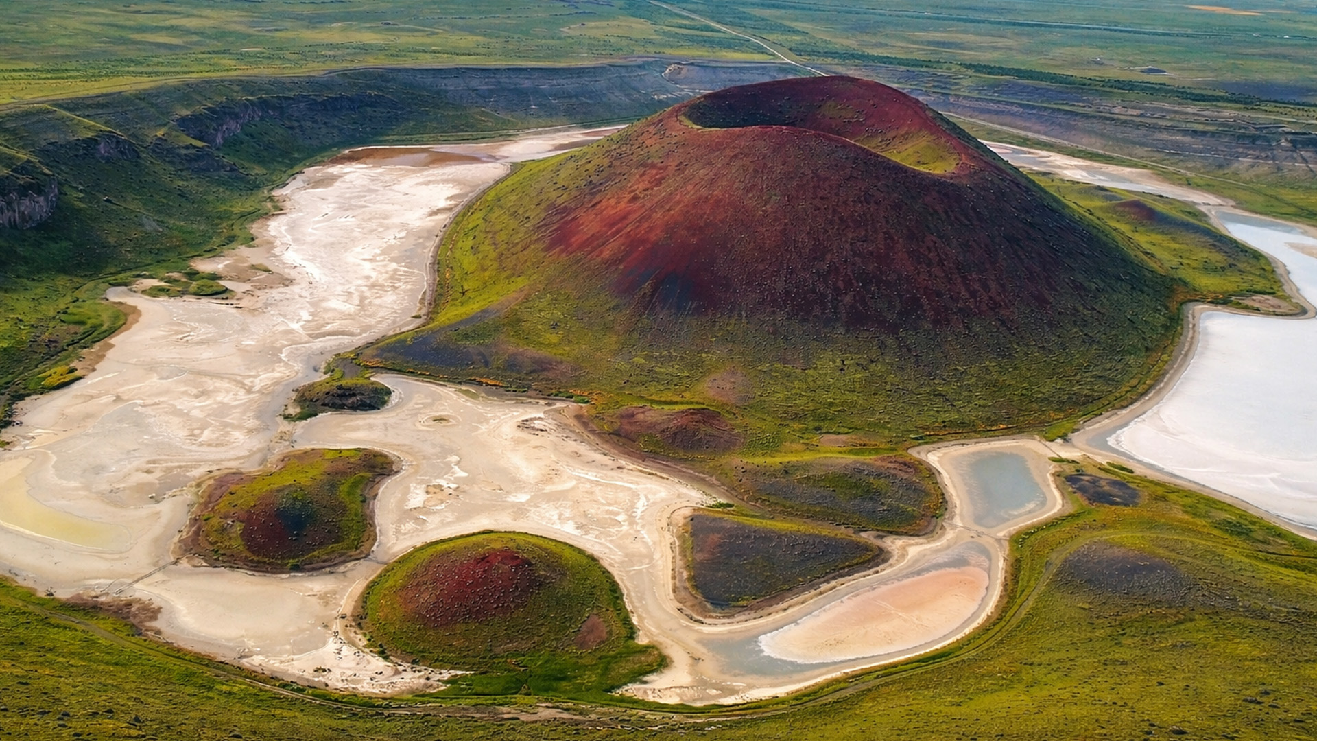 Why is there a volcano inside this crater?