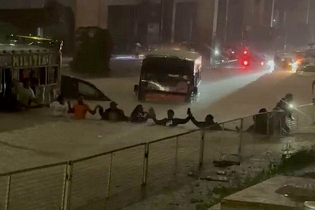 Commuters wade through submerged streets as Kenya floods death toll rises to 45<br>