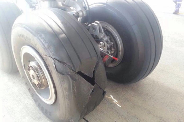 Moment Air India plane belly slides along runway after losing wheel