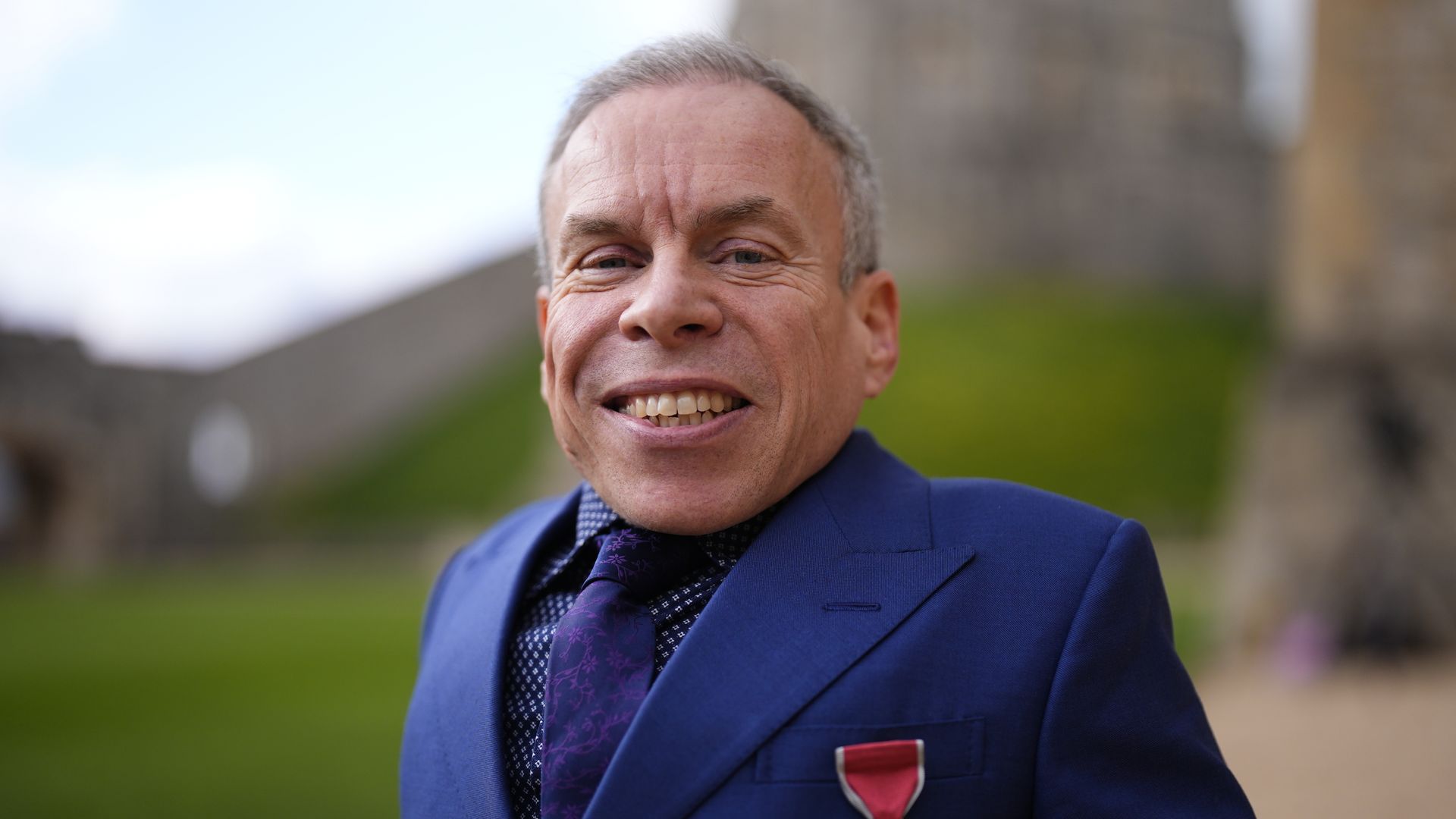 Warwick Davis celebrates OBE with his two children – and mystery companion