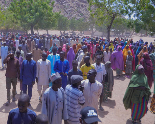 People gather for a meeting with the Borno state governor after fleeing an attack by Islamic militants. Photograph: Jossy Ola/AP